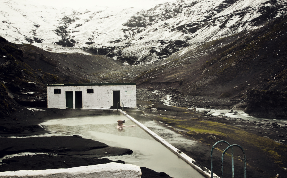 Knaldemand swimming in a country swimming pool in Iceland half overrun by volcanic ash.